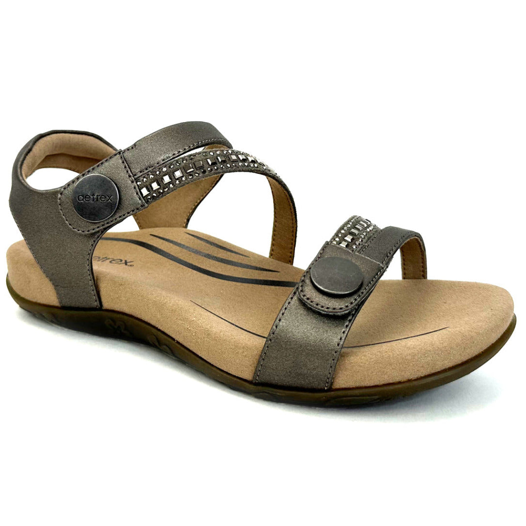 Sparkly pewter sandal with two adjustable straps, cushioned memory foam footbed, built-in orthotic arch support, and durable rubber outsole designed for stylish all-day comfort and pain relief.