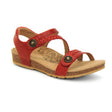 Red leather sandal with two wide adjustable hook-and-loop straps across the foot and a padded heel strap, contoured memory foam footbed with visible arch support, and a lightweight cork and rubber sole.