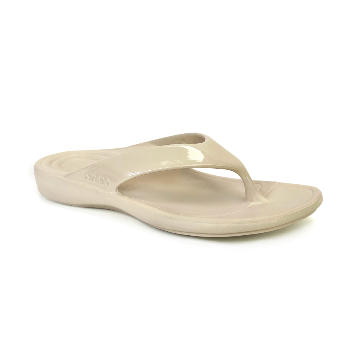 Ivory gloss flip-flop sandal with contoured footbed, soft toe post, and subtle shine. Made from single-piece UltraSky™ EVA foam with arch support and water-friendly construction for stylish pain relief in warm weather. Style #L31033W