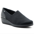 Women’s black waterproof slip‑on wedge with stretch fabric and hydro‑nappa leather upper, rounded toe, and roomy fit. Features a GORE‑TEX® membrane, cushioned removable insole, and flexible rubber sole for stylish, comfortable all‑weather wear. Style #406119-06