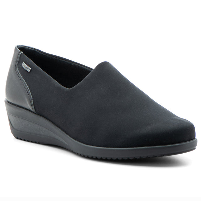 Women’s black waterproof slip‑on wedge with stretch fabric and hydro‑nappa leather upper, rounded toe, and roomy fit. Features a GORE‑TEX® membrane, cushioned removable insole, and flexible rubber sole for stylish, comfortable all‑weather wear. Style #406119-06