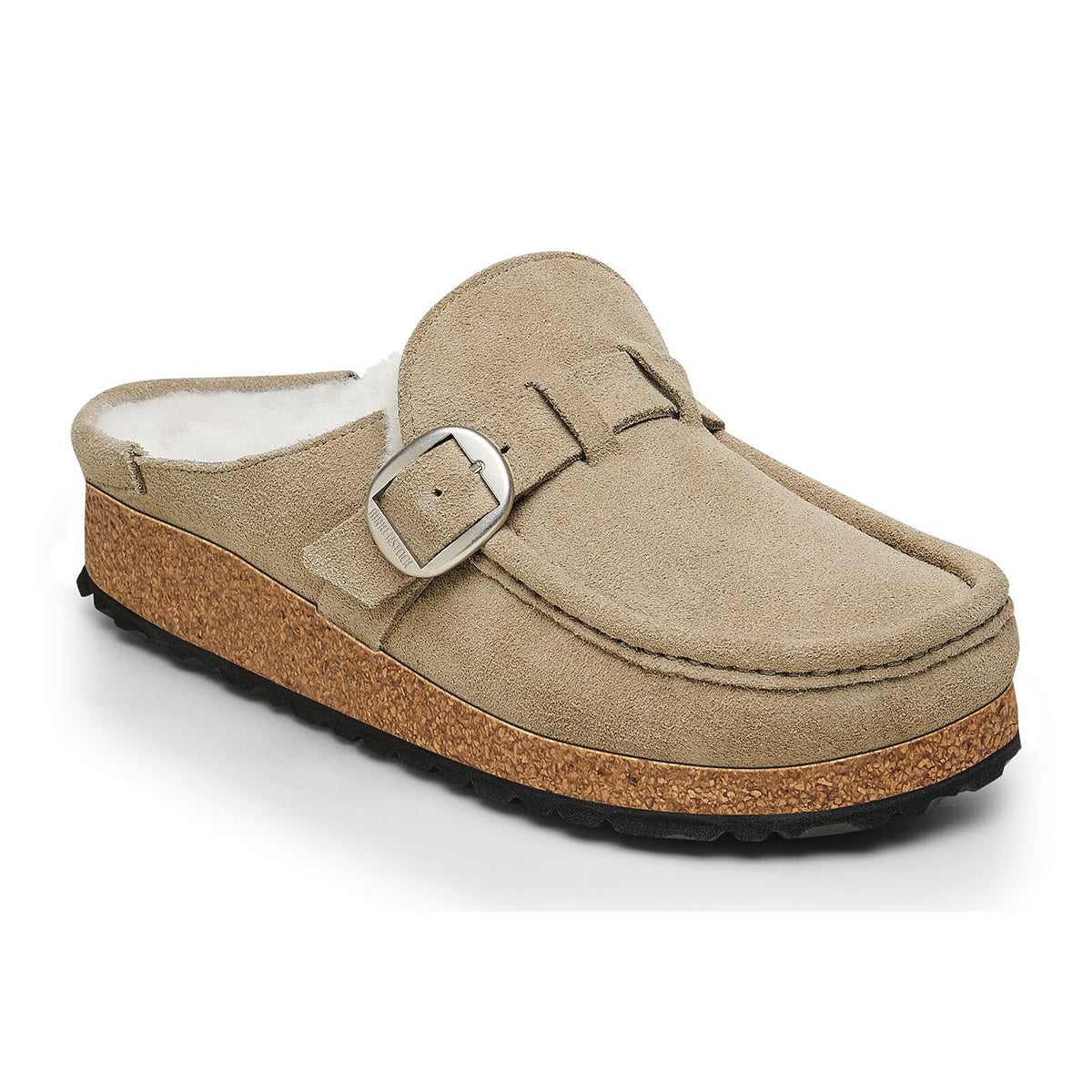 A beige Birkenstock Buckley shearling slipper with a buckle strap and a cork-latex sole.