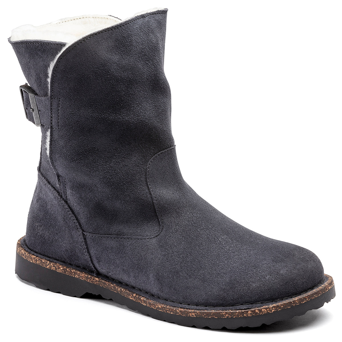A style image of the Uppsala Shearling Boot, which is a dark grey boot with a suede and shearling upper, a contoured cork footbed, and a rubber outsole.