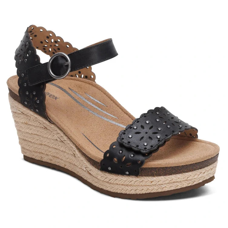 Black leather espadrille wedge sandal with cutout detailing, 3" jute-wrapped platform heel, hook and loop ankle strap, and built-in orthotic arch support. Designed for stylish support and summer comfort.