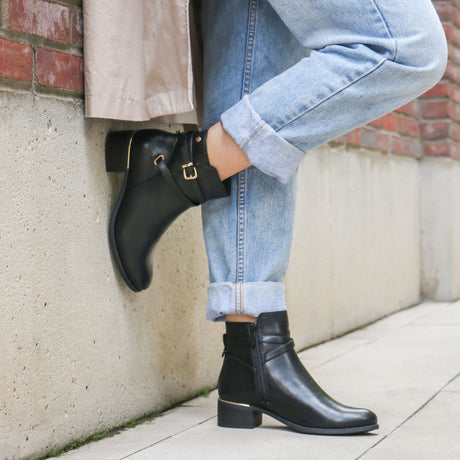 Lady Comfort Ava-01 Women’s Black Faux Leather Booties with plush faux fur lining, cushioned insole, gold-accented heel, full-length zipper, and rubber outsole. Shown on foot.