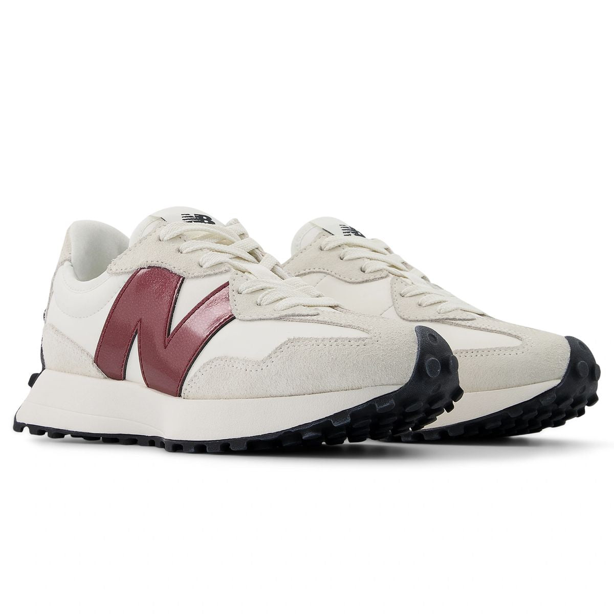 New Balance WS327JWC women’s runners in off-white suede with burgundy logo and black outsole, angled front-side view.