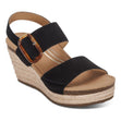 A black leather wedge sandal with a 3-inch jute-wrapped heel, adjustable straps over the toes and ankle, and a cushioned footbed—elegant and supportive for summer wear.