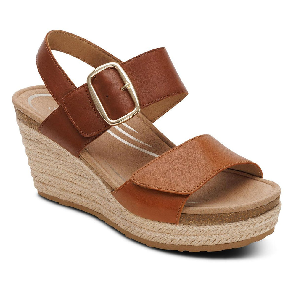 Women’s coffee brown leather wedge sandal with a large gold buckle, braided jute platform, and tan sole. Style #EW796