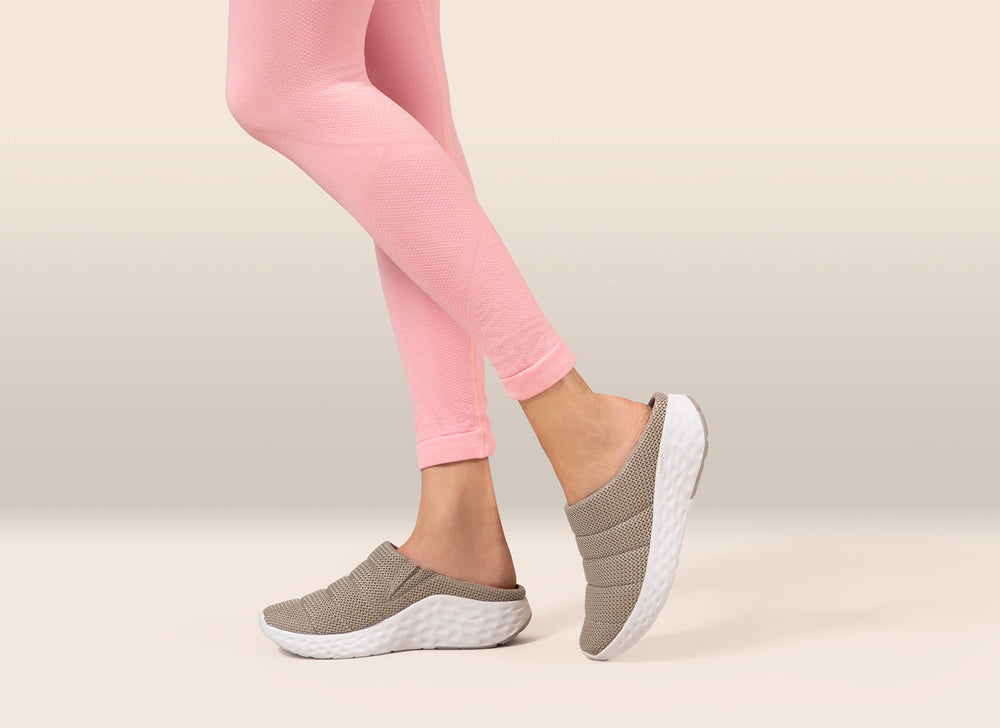 Black mesh slip-on shoe with stretchy gore panels, cushioned removable insoles, rubber pod outsole, and built-in arch support designed for comfort and foot pain relief.