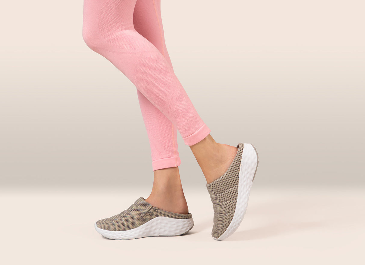 Black mesh slip-on shoe with stretchy gore panels, cushioned removable insoles, rubber pod outsole, and built-in arch support designed for comfort and foot pain relief.