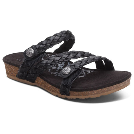 Women's Aetrex Josie black leather braided slide sandal with an adjustable top strap and visible ultra-light cork midsole.