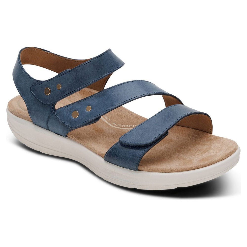 Women's blue leather sandal with three adjustable hook-and-loop straps, metallic stud accents, and a white sole. Style #EN2008