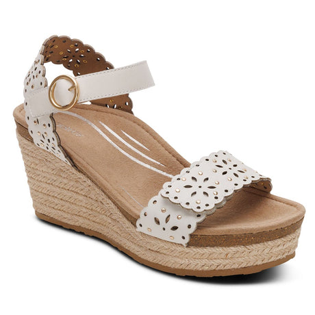 Women's ivory wedge sandal with laser-cut floral straps, a gold buckle, and a jute-wrapped espadrille sole. Style #EW773