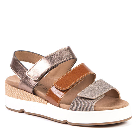 Women's tan wedge sandal with metallic, patent, and fabric straps, a cork-wrapped midsole, and white sole. Style #AP-11429
