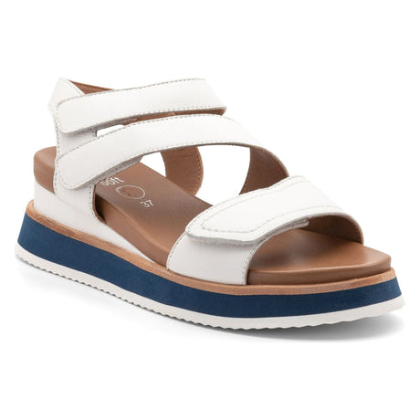 Women’s open‑toe sandal in smooth white leather with two adjustable hook‑and‑loop straps, cushioned footbed, and low wedge heel on a lightweight flexible sole for comfortable, stylish warm‑weather wear. Style #18205-09