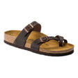 A brown oiled leather sandal with two straps and metal pin buckle fastening, on a cork footbed with EVA sole by Birkenstock. style is mayari.
