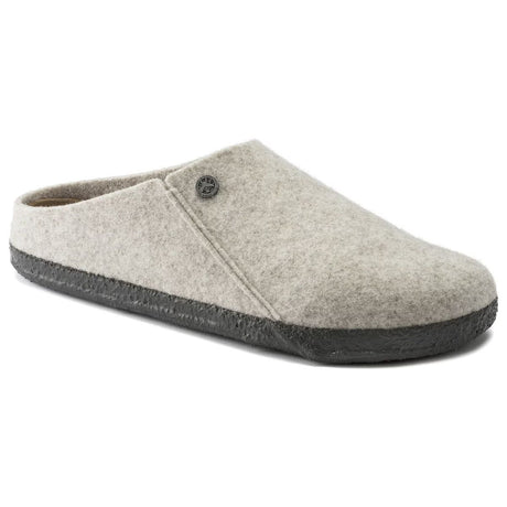 Off-white wool felt slip-on slipper with a metallic decorative rivet button and a black latex outsole. Style #1020068.