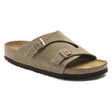 Birkenstock Zürich Soft Footbed slide in Taupe suede with two rose gold adjustable buckles and a natural cork sole. Style # 1009532