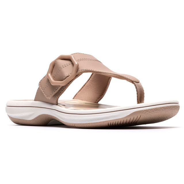 Sand-coloured thong sandal with a hexagonal buckle, cushioned footbed, and flexible sole. Style #26186798