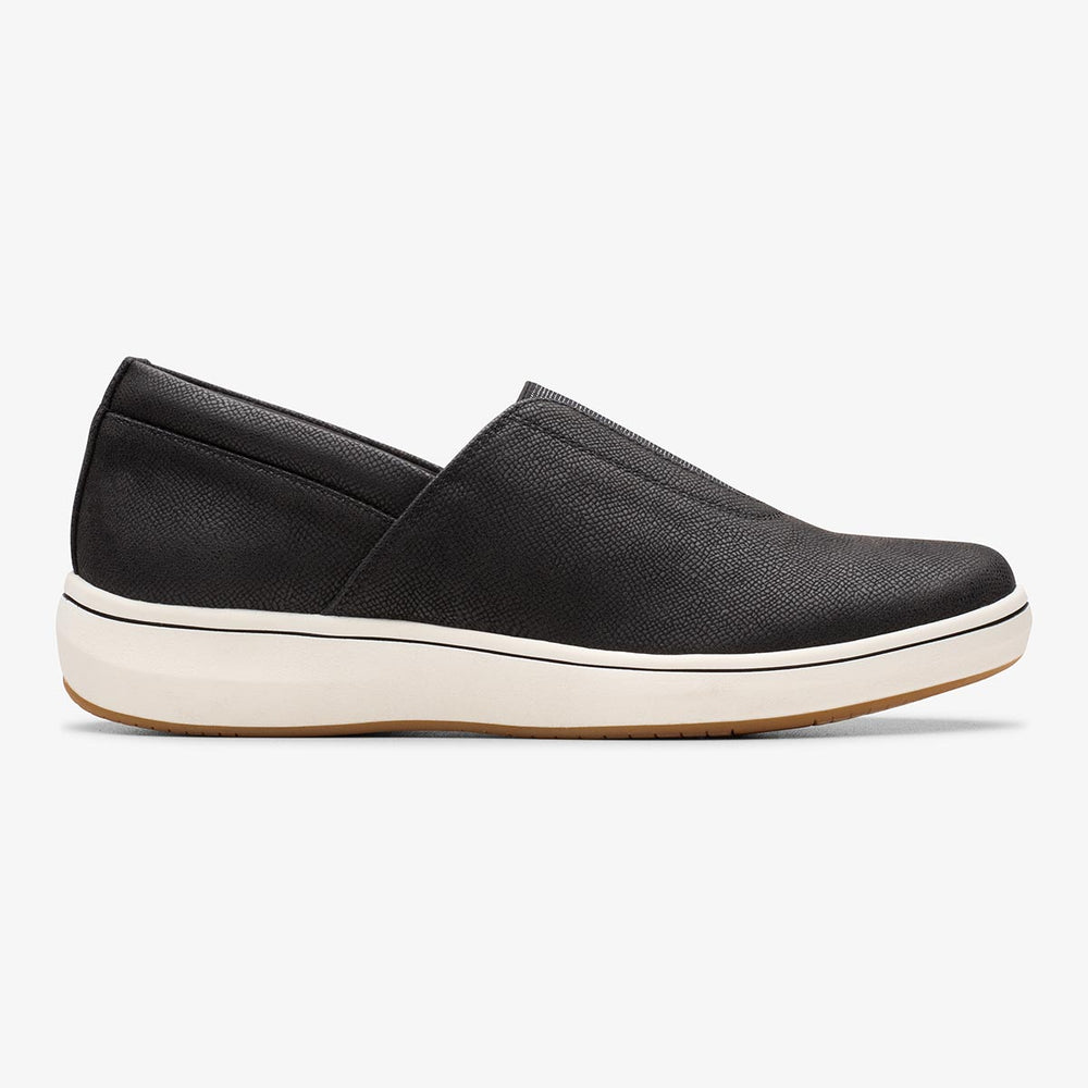Clarks BreezeSky Ria black slip-on sneaker with a subtle textured upper and a thick white sole. Style: 26184296