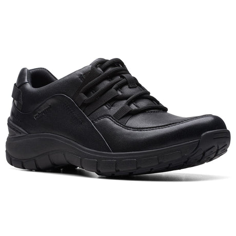 Women’s all-black leather walking sneaker featuring integrated athletic laces and a thick, textured black sole. Style #26174865.