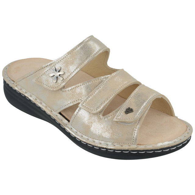 Metallic shell-coloured leather slide sandal with two adjustable velcro straps, floral accent, and black sole. Style #2640843525