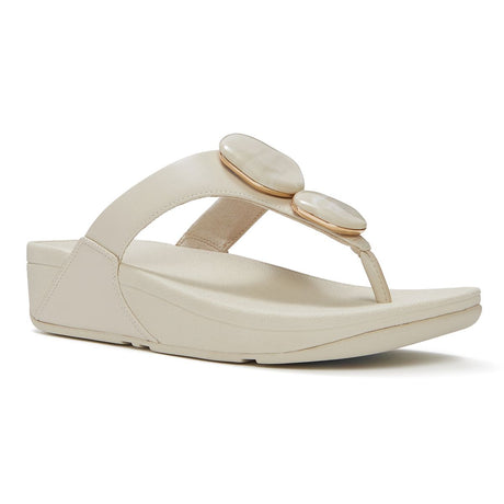 Women's beige leather thong sandal featuring two marbled stones with gold rims on the strap and a wedge sole. Style #A4L-A99
