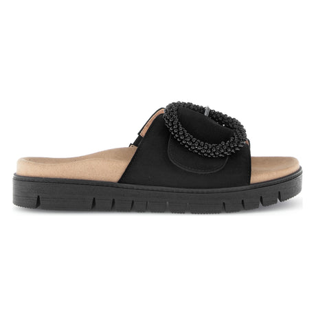 Women's black suede slide sandal with a large beaded buckle, tan contoured footbed, and a thick black sole. Style #745.17