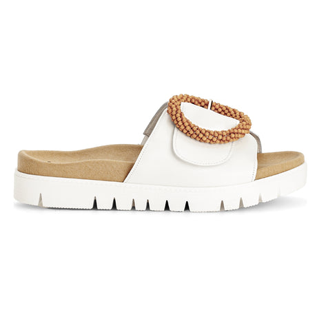 Women's white leather slide sandal with a large beaded buckle, tan contoured footbed, and a white platform sole. Style #745.21