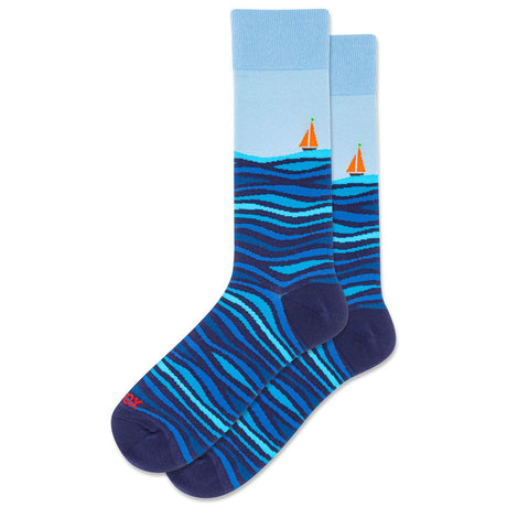 Blue crew socks featuring a nautical pattern of ocean waves and small orange sailboats with a light blue top. Style #HSM10427