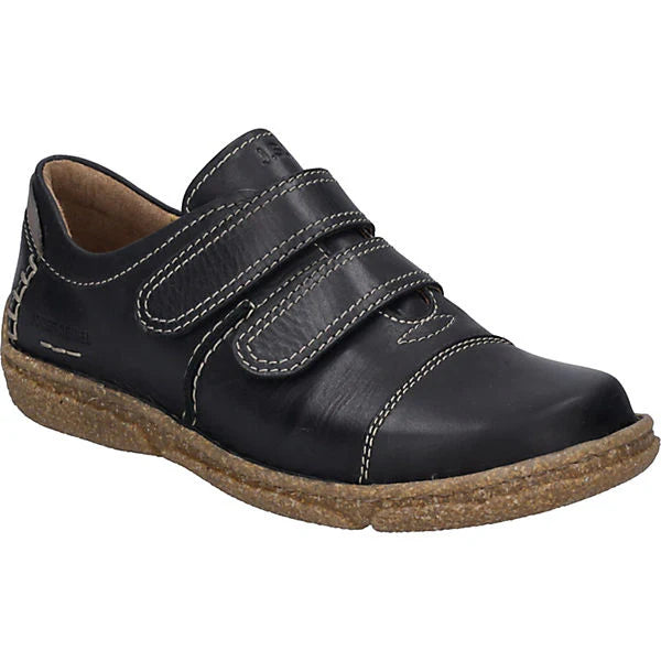 Women’s black leather walking shoe with two adjustable velcro straps, contrast stitching, and a textured tan sole. Style #851652100