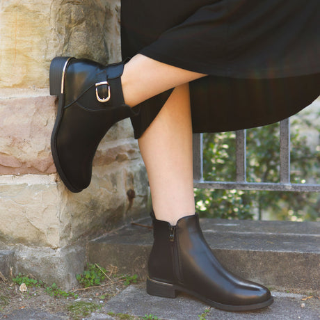 Lady Comfort Charlotte-01WP Women’s Black Waterproof Booties with faux fur lining, cushioned insole, gold buckle and heel accents, and traction outsole. On foot.
