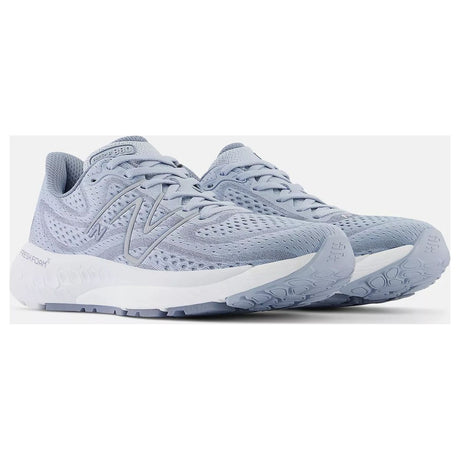 Women's light blue-grey engineered mesh running shoes with a grey side logo and thick white cushioned sole. Style #W880G13.