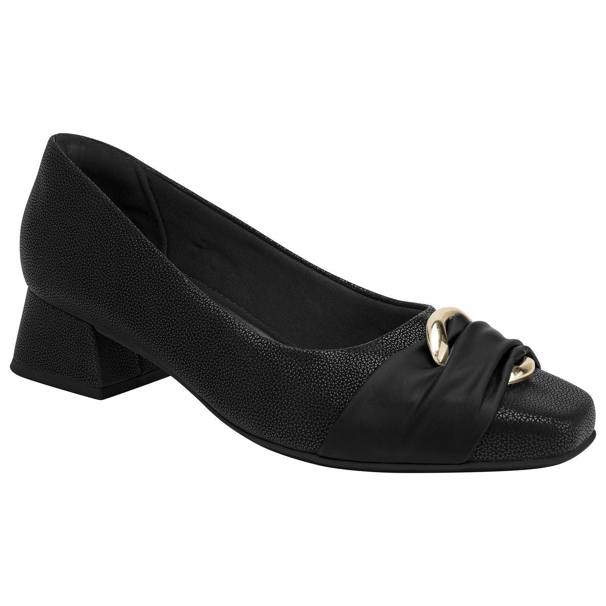 Women’s black textured dress pump featuring a low block heel, a square toe, and a decorative front metallic ornament. Style #160113B.