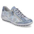 Blue floral leather low-top sneaker with laces and side zipper, style # R1402, on a textured grey wedge sole.