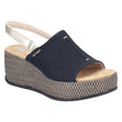 Women's black slide sandal with metallic silver slingback strap, woven pattern wedge, and tan footbed. Style #69460-00