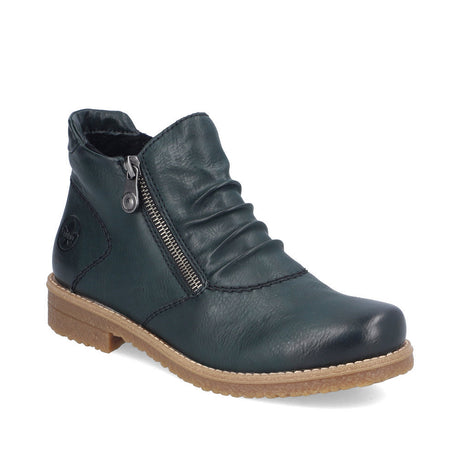 Women’s blue-green ankle boot with ruched synthetic leather upper, side zipper, soft lining, and a low block heel on a textured sole. Style #73553-54