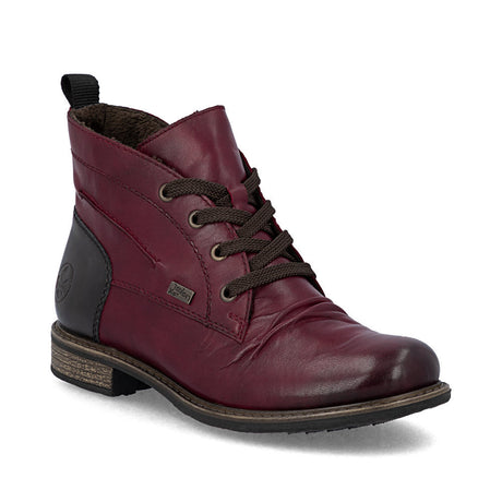 Red women's lace-up boot with leather upper, side zipper, padded insole, rugged sole, and water-repellent design for stylish winter support. Style #74804-35