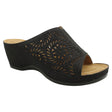 Women’s black slide sandal with intricate laser-cut patterns, shimmering accents, and a comfortable wedge heel. Style # S5036.