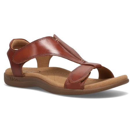 Cognac leather T-strap sandal with adjustable hook-and-loop closures and a contoured tan footbed.