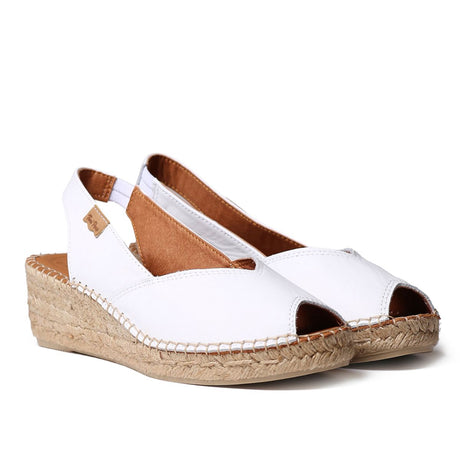Women’s white leather wedge espadrille with peep toe, hand-stitched jute platform, and elastic slingback strap for a clean, summer-ready silhouette.