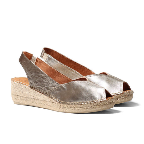 Women’s platinum peep-toe wedge espadrille with jute-wrapped platform, elastic slingback strap, and hand-stitched details for a breezy summer look. Style #P1705
