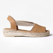 Women’s tan leather flat sandal with elastic cross-straps and a braided jute espadrille sole.