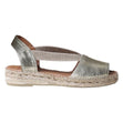 Women’s metallic gold leather flat sandal with elastic cross-straps and a braided jute espadrille sole.