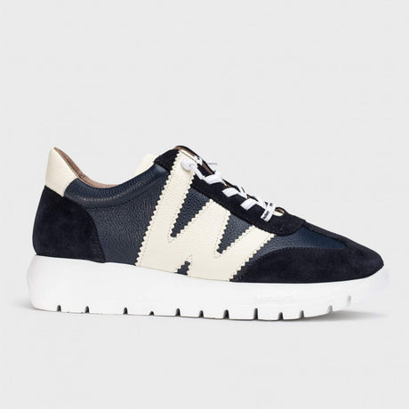 Wonders A2476 women's navy blue racer sneaker with a cream-colored W-shaped design on the side and a chunky white sole